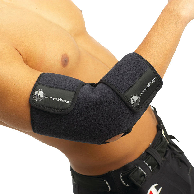 A person wearing a black ActiveWrap elbow support wrap on their arm, showing the brand's logo on the wrap's adjustable straps.