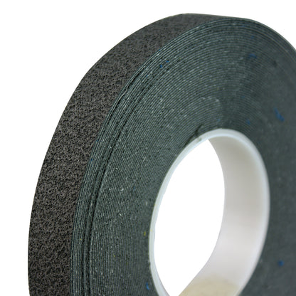 Close-up of a roll of Cushion Grip Tape, showing its textured black surface and a white core.