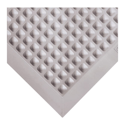 Close-up of the Wearwell Autoclavable Anti-Fatigue Mat, showing a textured, raised diamond pattern in a corner view.