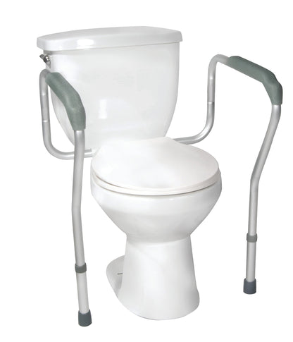The Drive Medical Adjustable Toilet Safety Frame is attached to a toilet, featuring sturdy gray handles for added support.