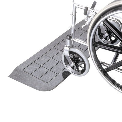 A wheelchair on an EZ Edge Threshold Ramp, featuring a textured, sloped surface for easy access and mobility.