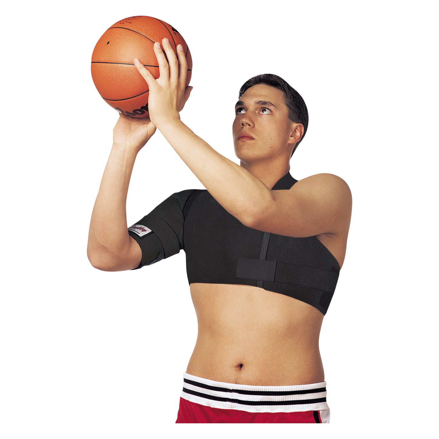 A person wearing a Sully Shoulder Stabilizer is preparing to shoot a basketball, focusing intently while holding the ball overhead.