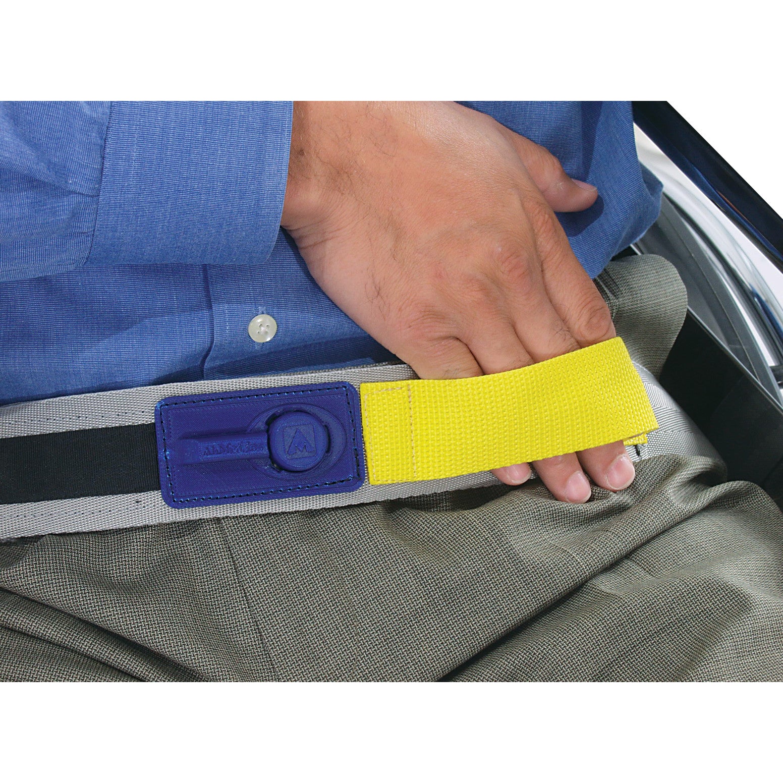A person demonstrates the AliMed E-Z Release Seatbelt with Basic Alarm, featuring a yellow pull strap and blue buckle component.