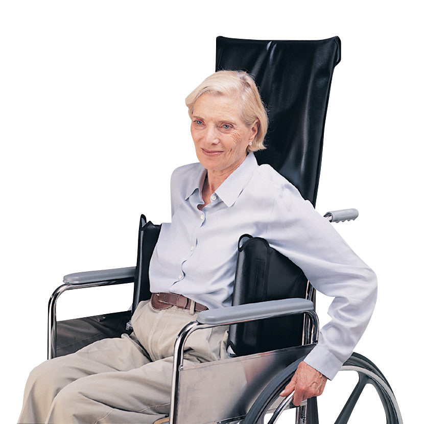 An elderly person is seated in a wheelchair using a SkiL-Care Lateral Support Orthosis (LSO) for added side support and comfort.