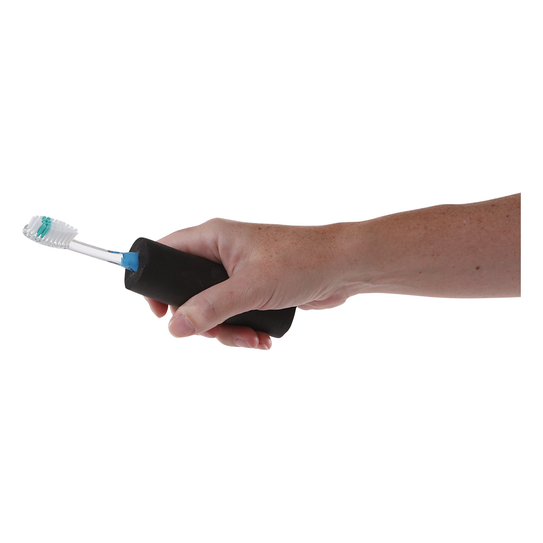 A hand holds a Foam Padded Utensil Gripper with a toothbrush inserted, designed for easier handling and grip.