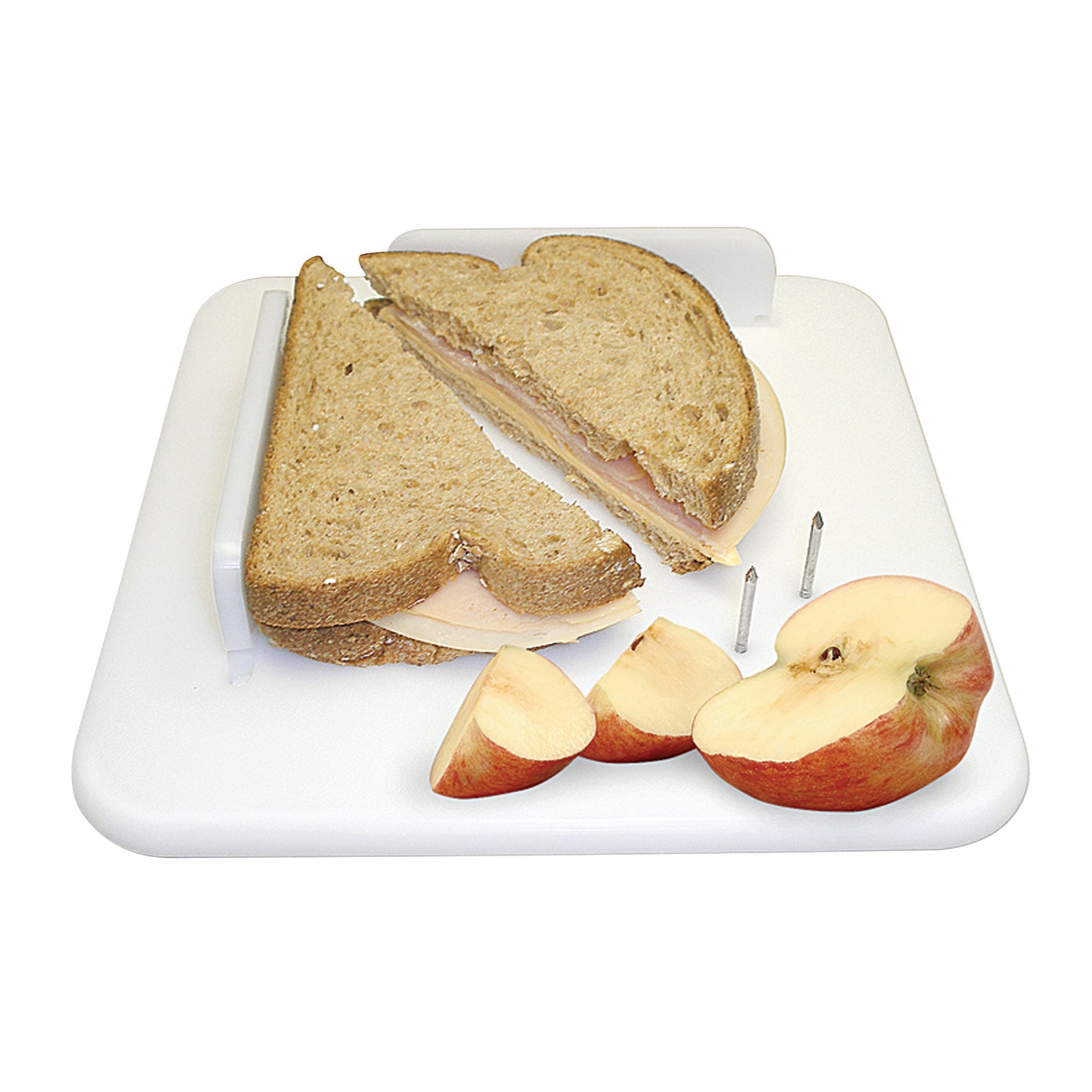 The Therafin Plastic Paring Board holds a sandwich and sliced apple securely with pegs on a white cutting surface.