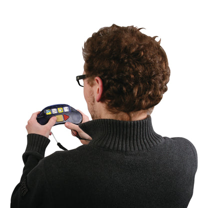 A person uses the StepPad Communication Device, featuring a screen with icons and buttons, held with both hands.