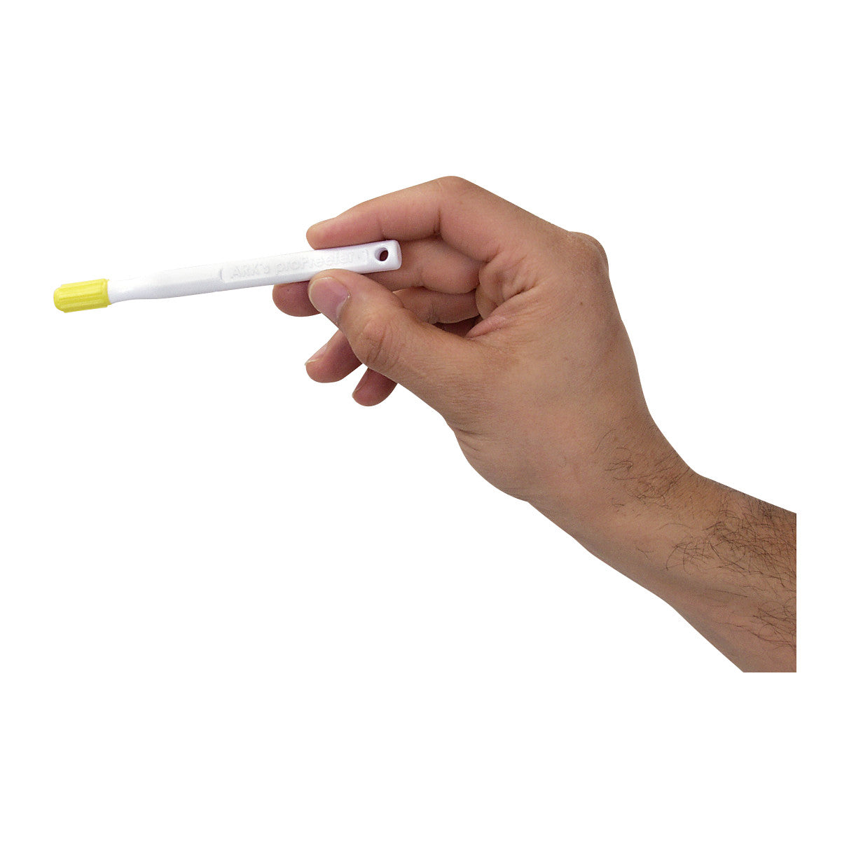 A hand holds the ARK Oral Motor proPreefer, a white tool with a yellow tip, designed for oral motor exercises.