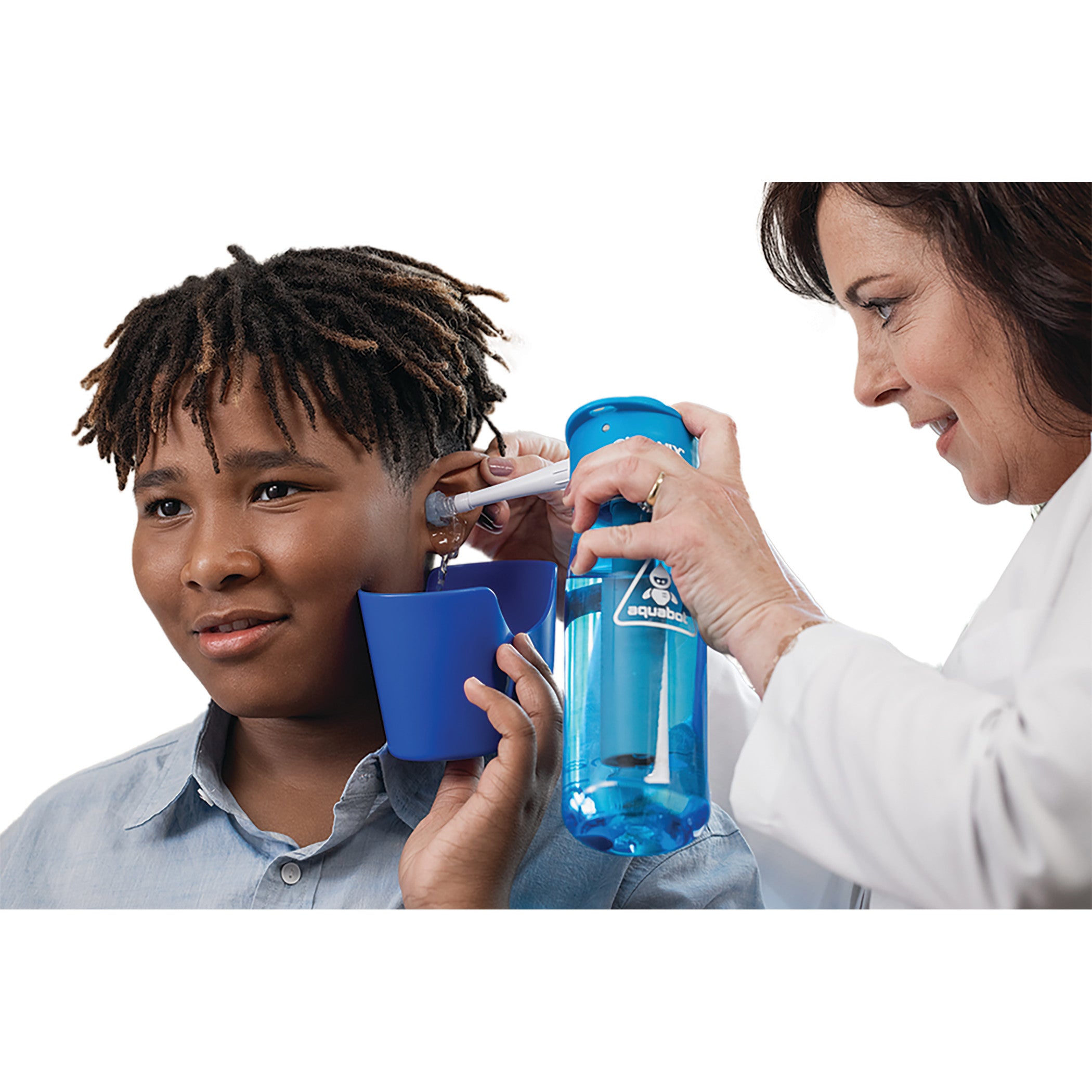 A person receives ear irrigation using the Bionix OtoClear Aquabot Ear Irrigation System, shown with a blue bottle and shield.