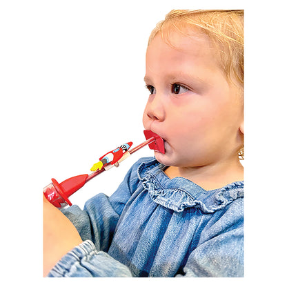 A toddler uses the TheraSIP RocketSIP, a red rocket-themed straw, while wearing a blue denim shirt.