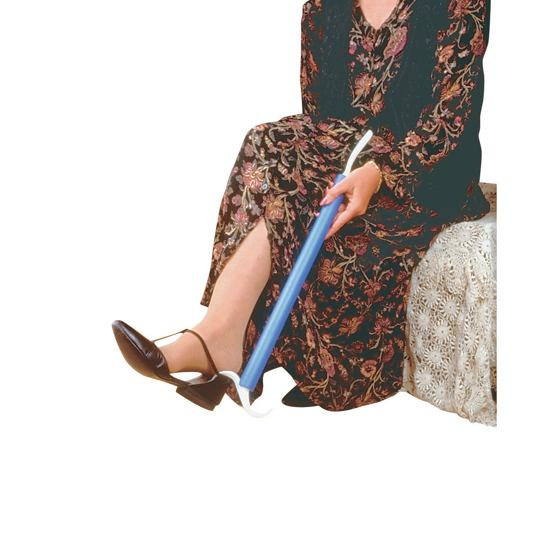 A person uses the Dress EZ, a blue long-handled shoehorn, while sitting, assisting with putting on a black shoe.