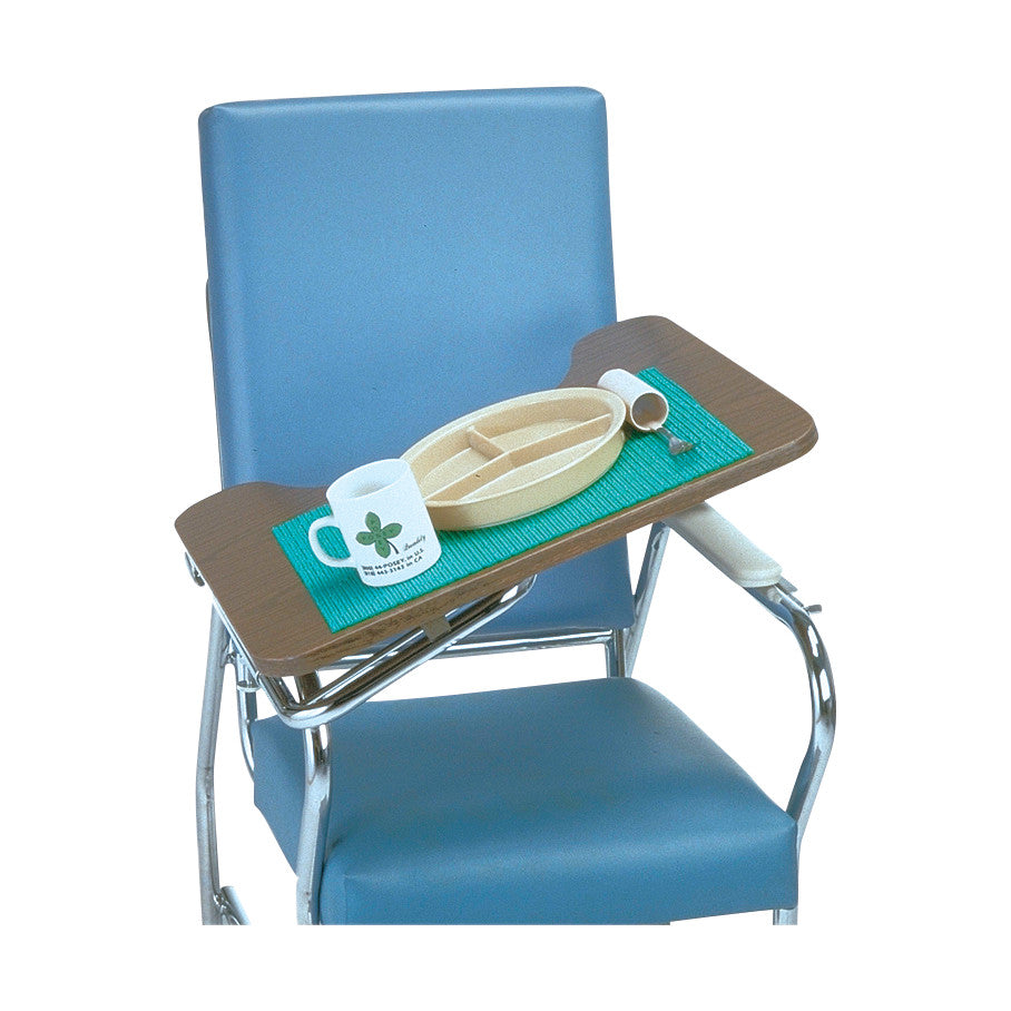 A blue chair with a folding tray containing a Posey Grip, a divided plate, a mug, and utensils. The Posey Grip is a turquoise mat.