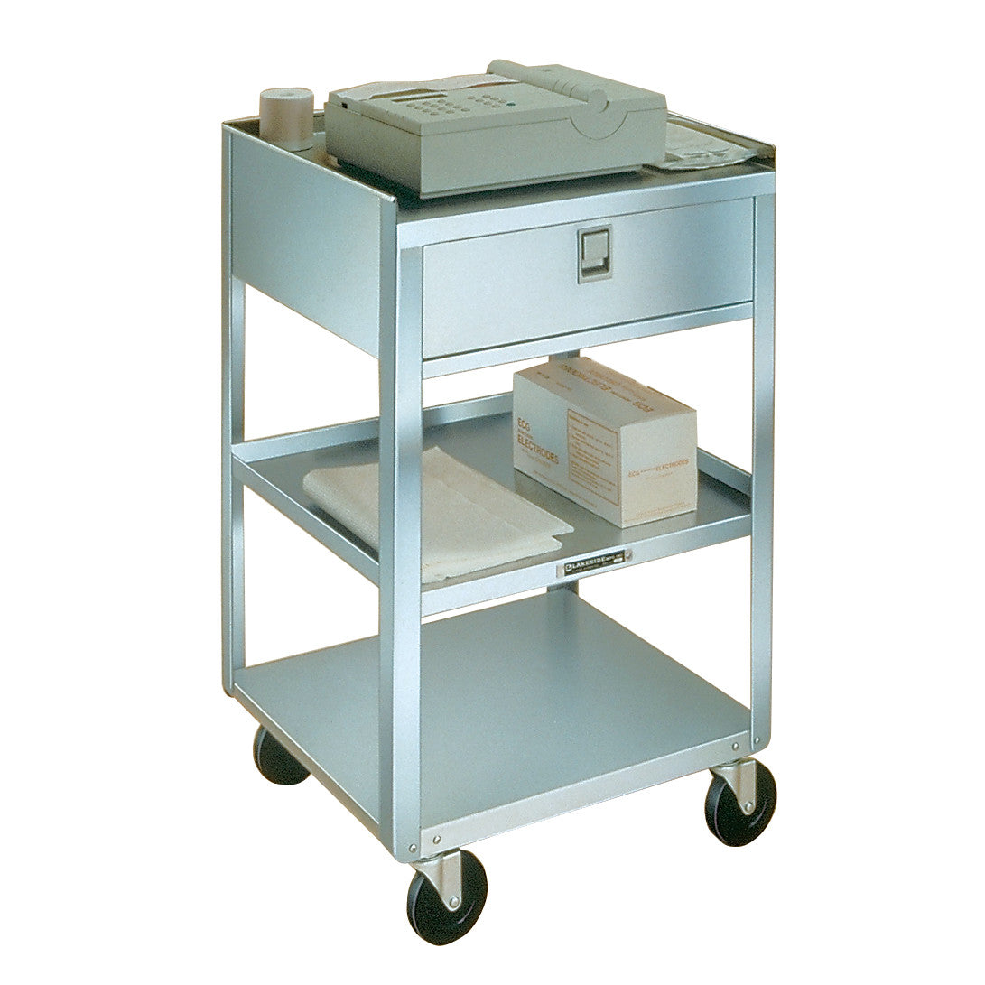 A Lakeside Stainless Steel Equipment Stand with three shelves, a drawer, and wheels. It holds a device and several boxes.