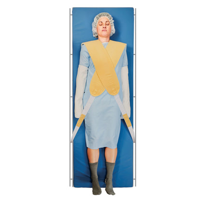 A person lies on a blue mat wearing an AliMed Cervical Visualization Harness, with straps across the body and a cap.