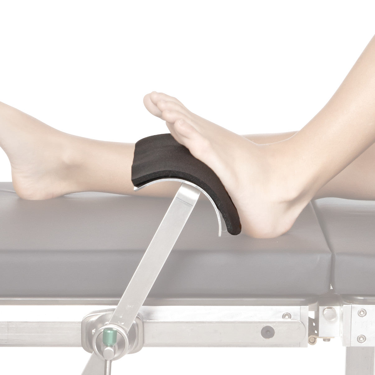 A leg rests on a Disposable Foot Pad for AliMed TKR Footrest, placed on a metallic support, atop a cushioned medical table.