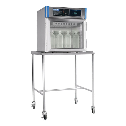 A mobile stand for the Blickman Warming Cabinet is shown. The cabinet, on a metal stand with wheels, holds jars inside.