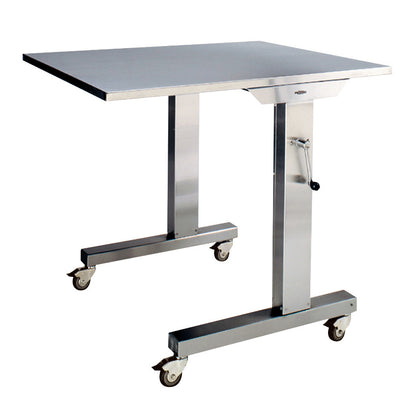 The Pedigo Over Operating Table is a stainless steel table on wheels, featuring an adjustable height crank mechanism.