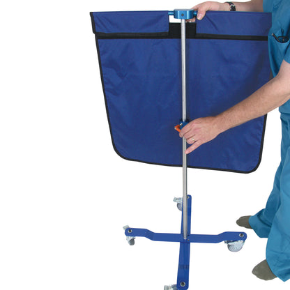 A person adjusts an AliMed Rolling Radiation Shield, featuring a blue fabric panel and a metal frame with wheels for mobility.