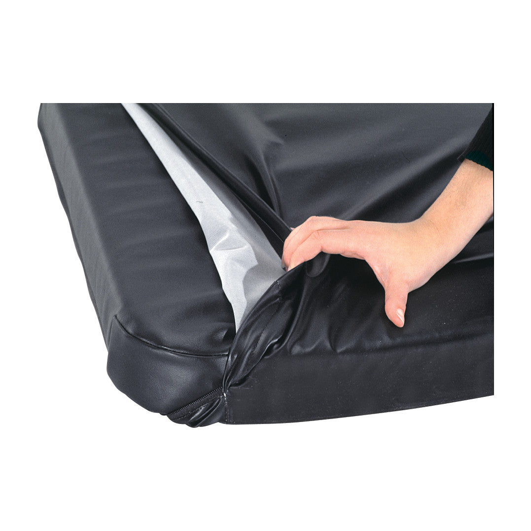 A hand holds the edge of an AliMed MRI Stretcher Surface Replacement Cover, revealing its inner lining. The cover is black.