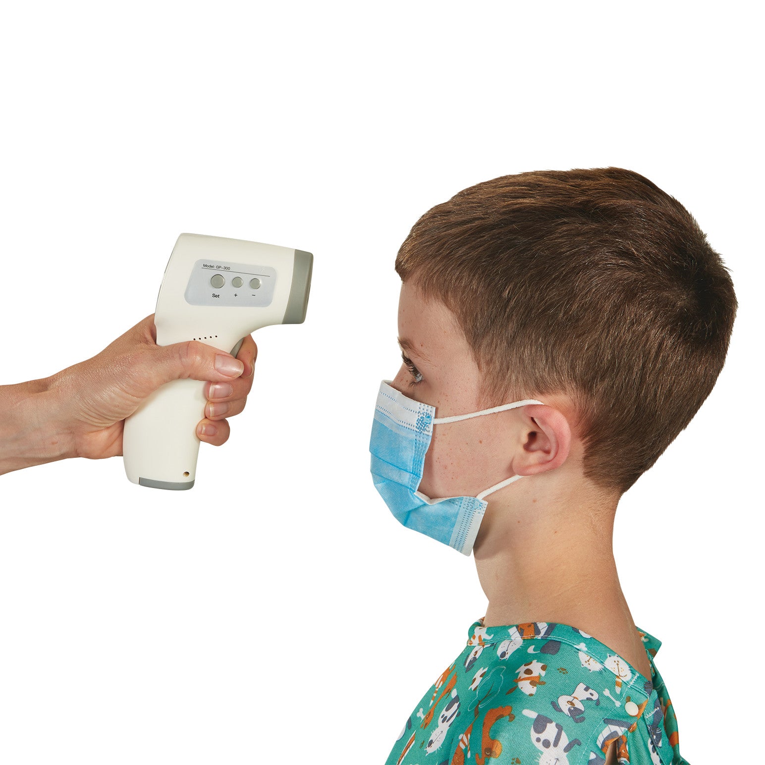 A person uses an IR Thermometer to check the temperature of a child wearing a mask and hospital gown with playful prints.