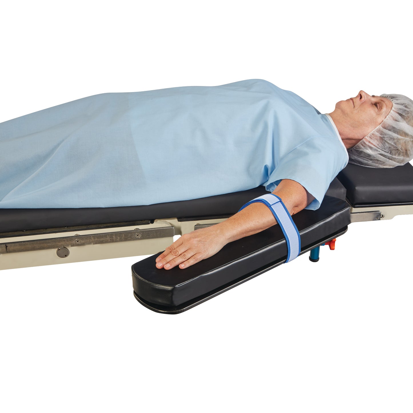 A person lies on a medical table with an AliMed AliStrap Precut Patient Safety Strap securing their arm on an armboard.