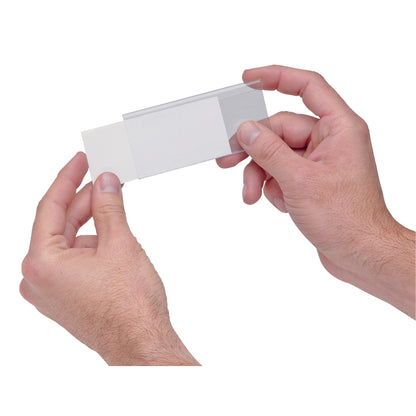 Hands hold a clear label holder and insert for Quantum Ultra Stack and Hang Bin. The holder is transparent with a white insert.