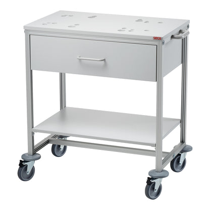 A white Seca 403 Mobile Cart for Baby Scale with a handle, drawer, lower shelf, and four swivel wheels.