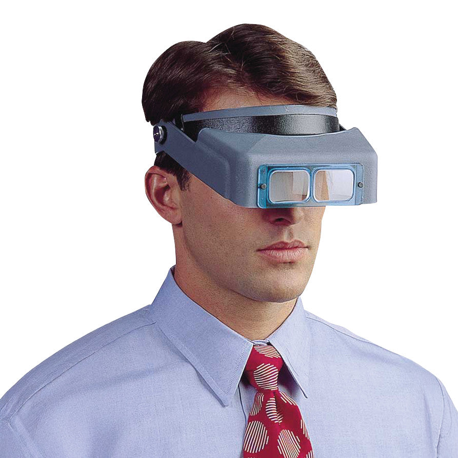 A person wears an OptiVISOR Headband Magnifier with blue lenses, over a shirt and red tie, against a plain background.