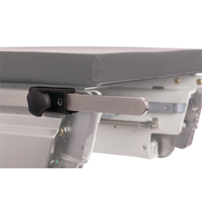 The KYRA Side Rail Extender is attached to a hospital bed, featuring a metal arm and a black adjustment knob.