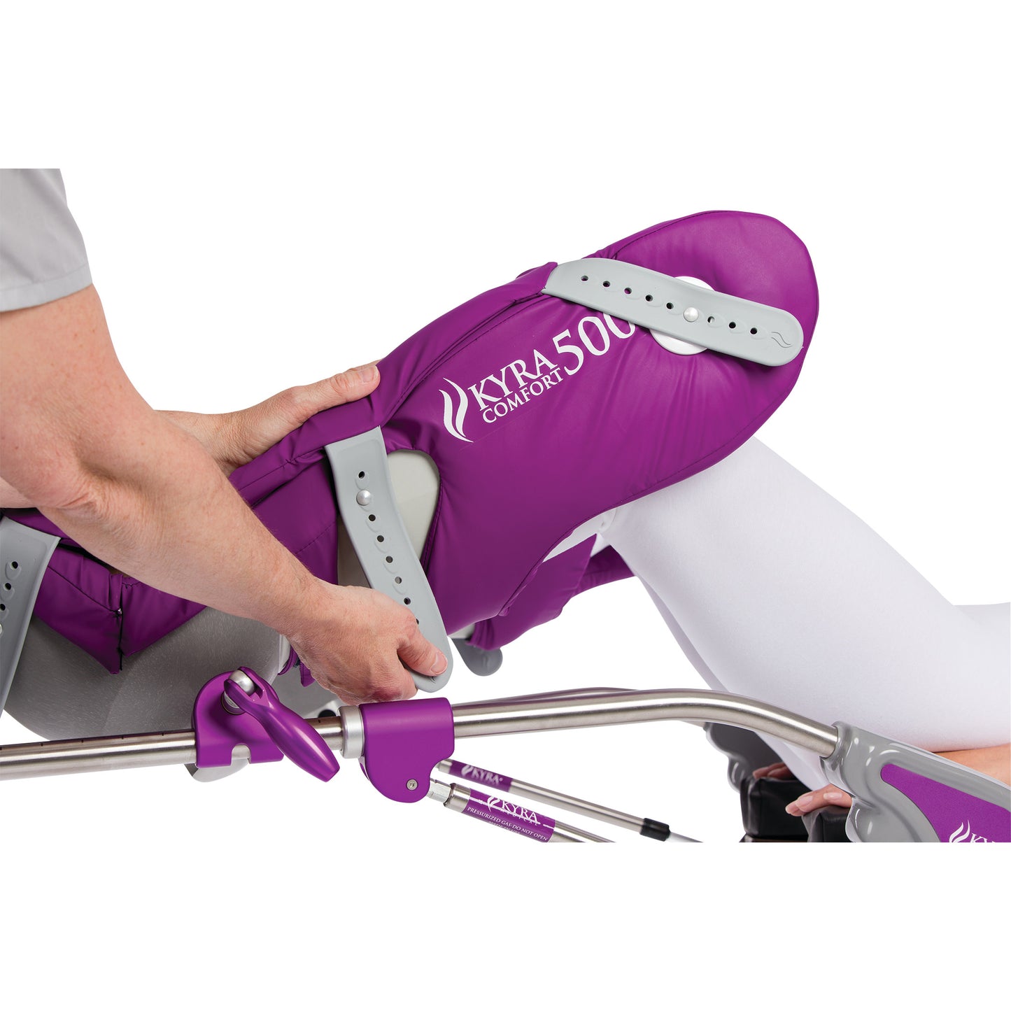 A person adjusts the KYRA Comfort 500 Lithotomy Stirrup, featuring purple padding and Secure-Lok Straps, on a metal framework.