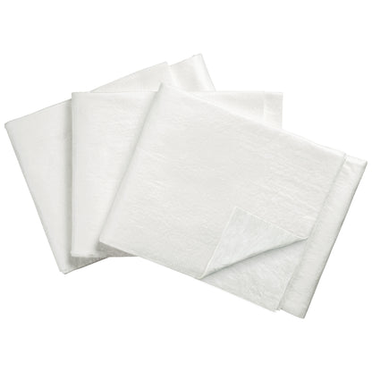 Four SpilfyterMED White Absorbent Mats for Emergent Use are stacked. One mat's corner is folded, showing its thickness.
