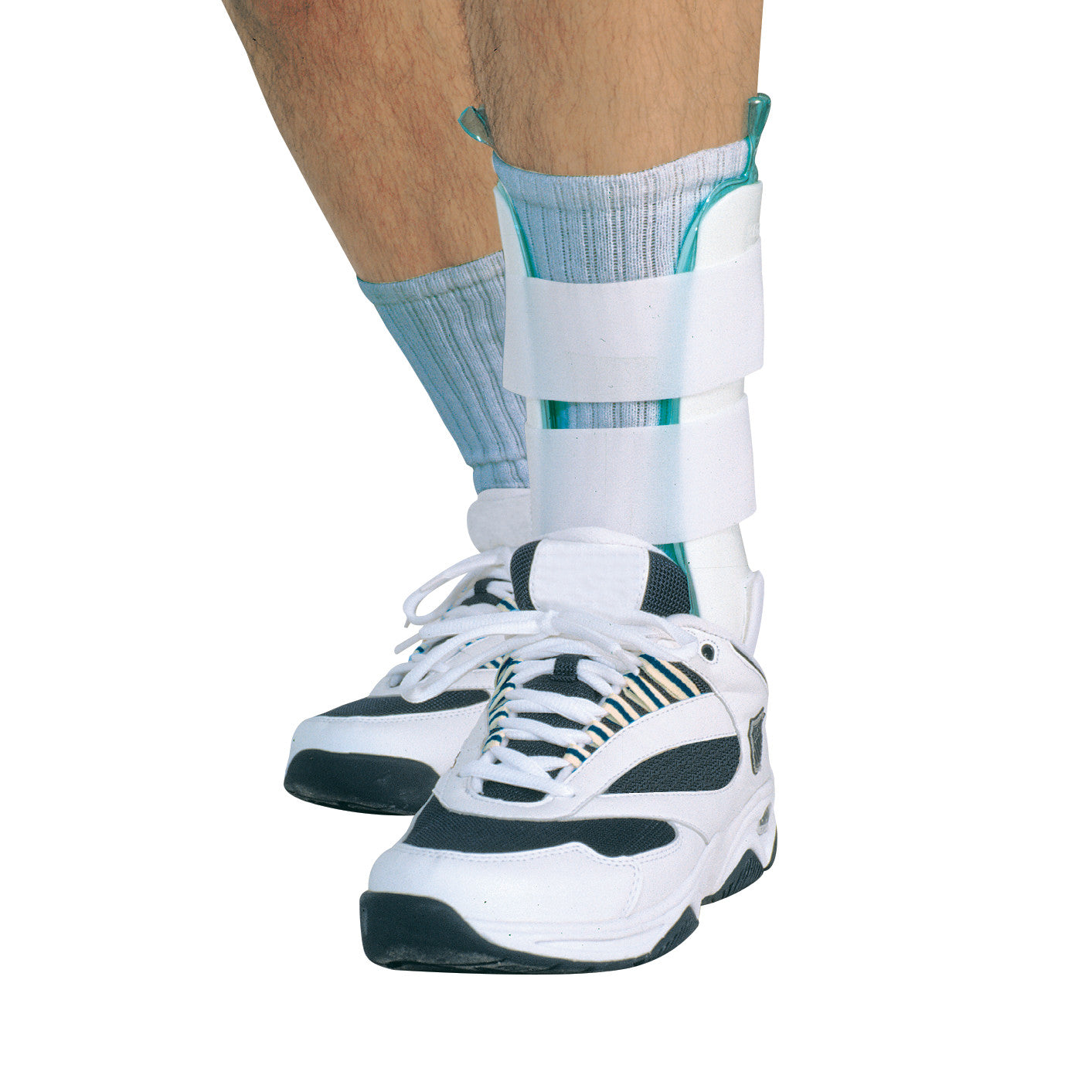 A person wearing an AliMed Ankle Brace with All-Air Liner and white athletic shoes, with the brace secured over their socks.
