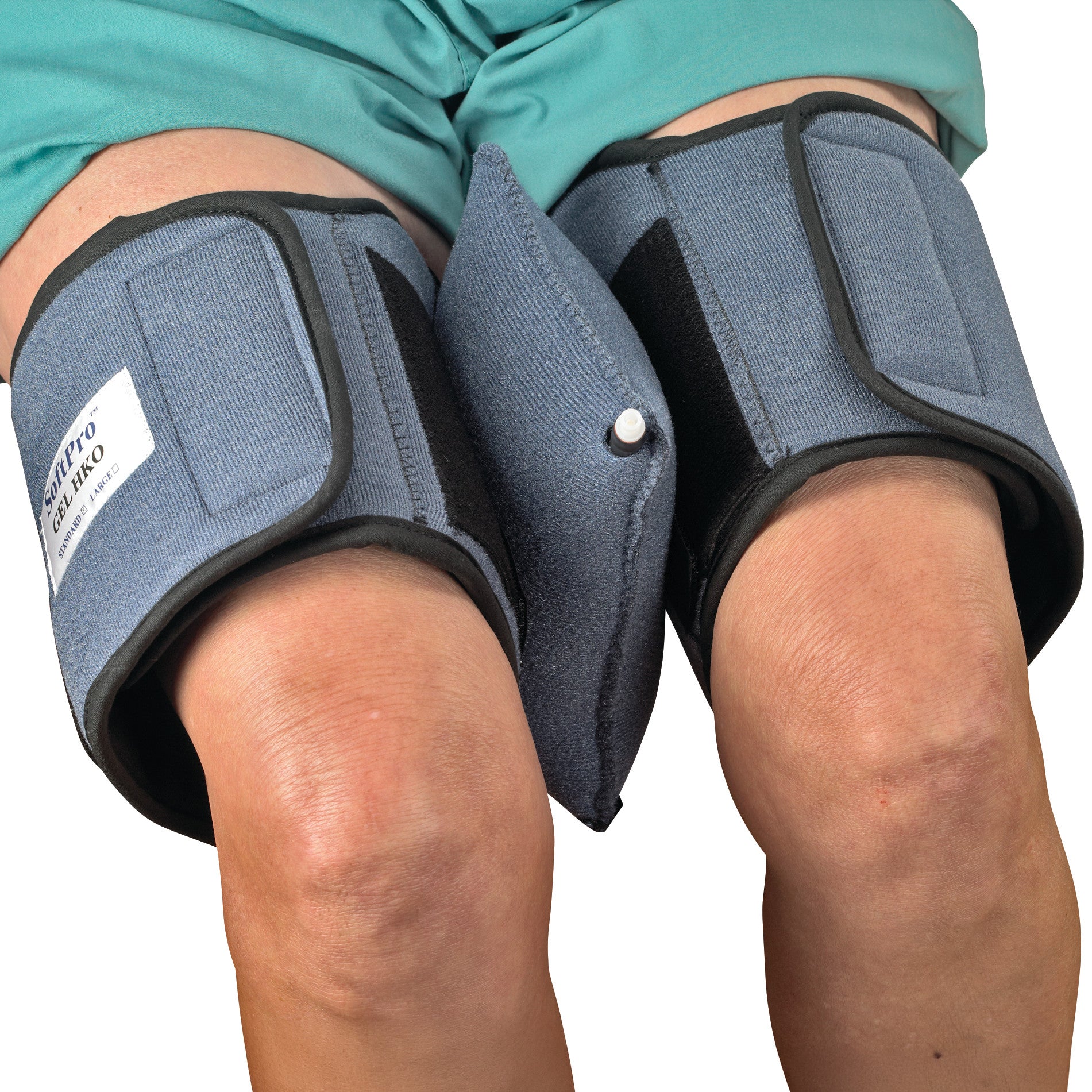 The image depicts knees with blue wraps and a central pad from the OCSI SoftPro Air Bladder Starter Kit for therapeutic use.