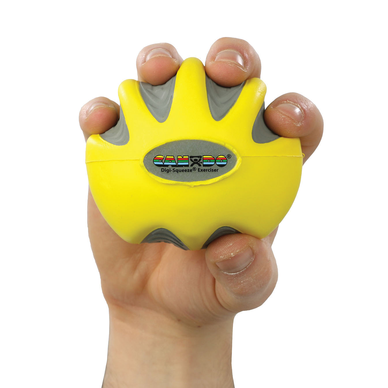 A hand grips a yellow and gray CanDo Digi-Squeeze Hand Exerciser, featuring an oval label in the center.