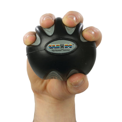 A hand grips a CanDo Digi-Squeeze Hand Exerciser, a black spherical tool for strengthening fingers and hands.
