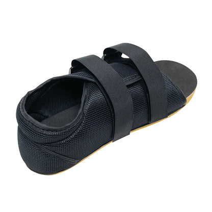 Black Canvas Post-Op Shoe with two adjustable straps and a thick sole designed for foot support after surgery or injury.