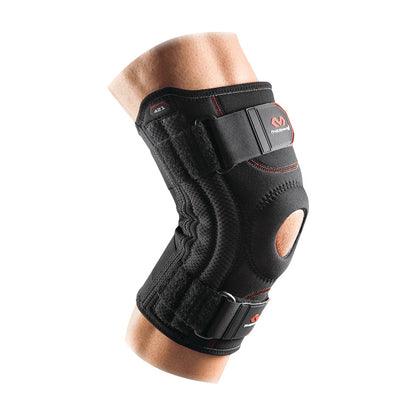 A McDavid Patella Knee Support on a leg, featuring adjustable straps and an open patella design for stability.