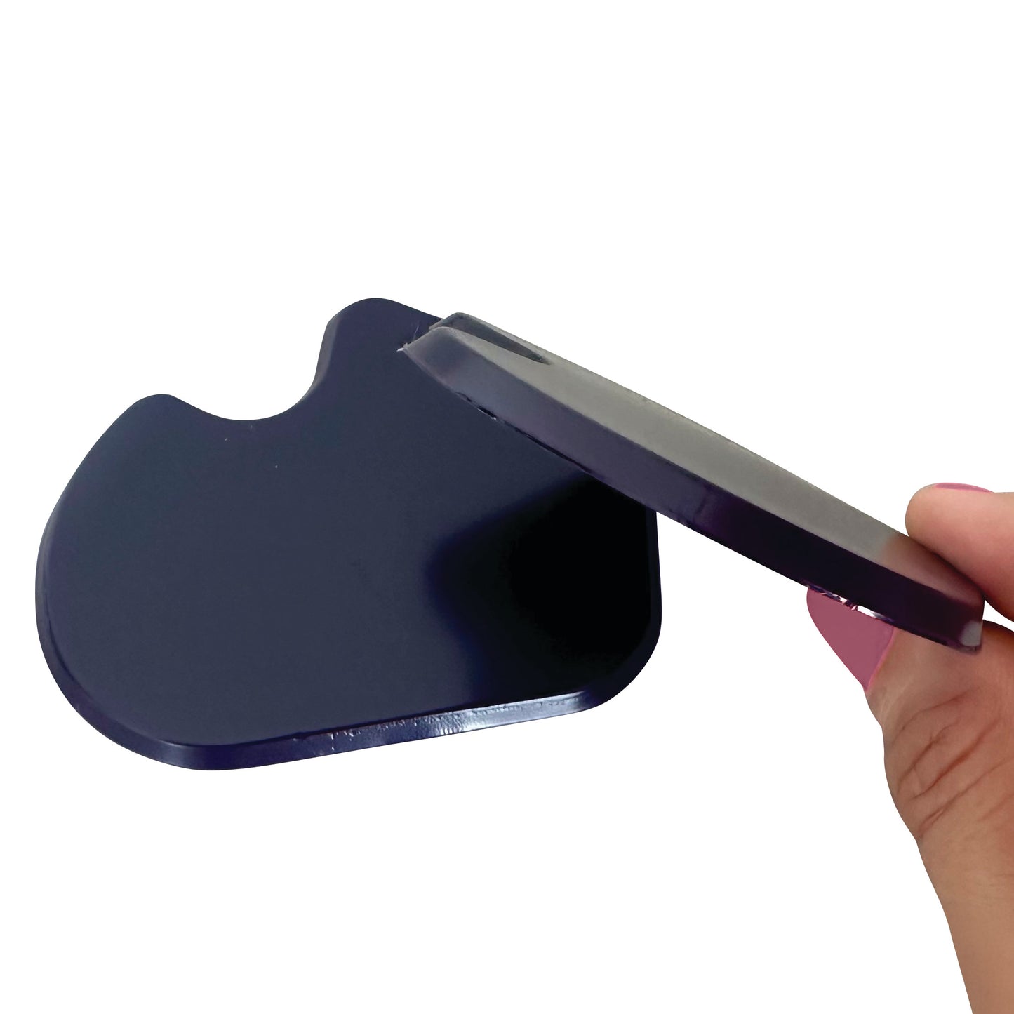 A person holds a Gel Dancer Met Pad, showing its curved, dark, smooth surface with a groove on one side for comfort and support.