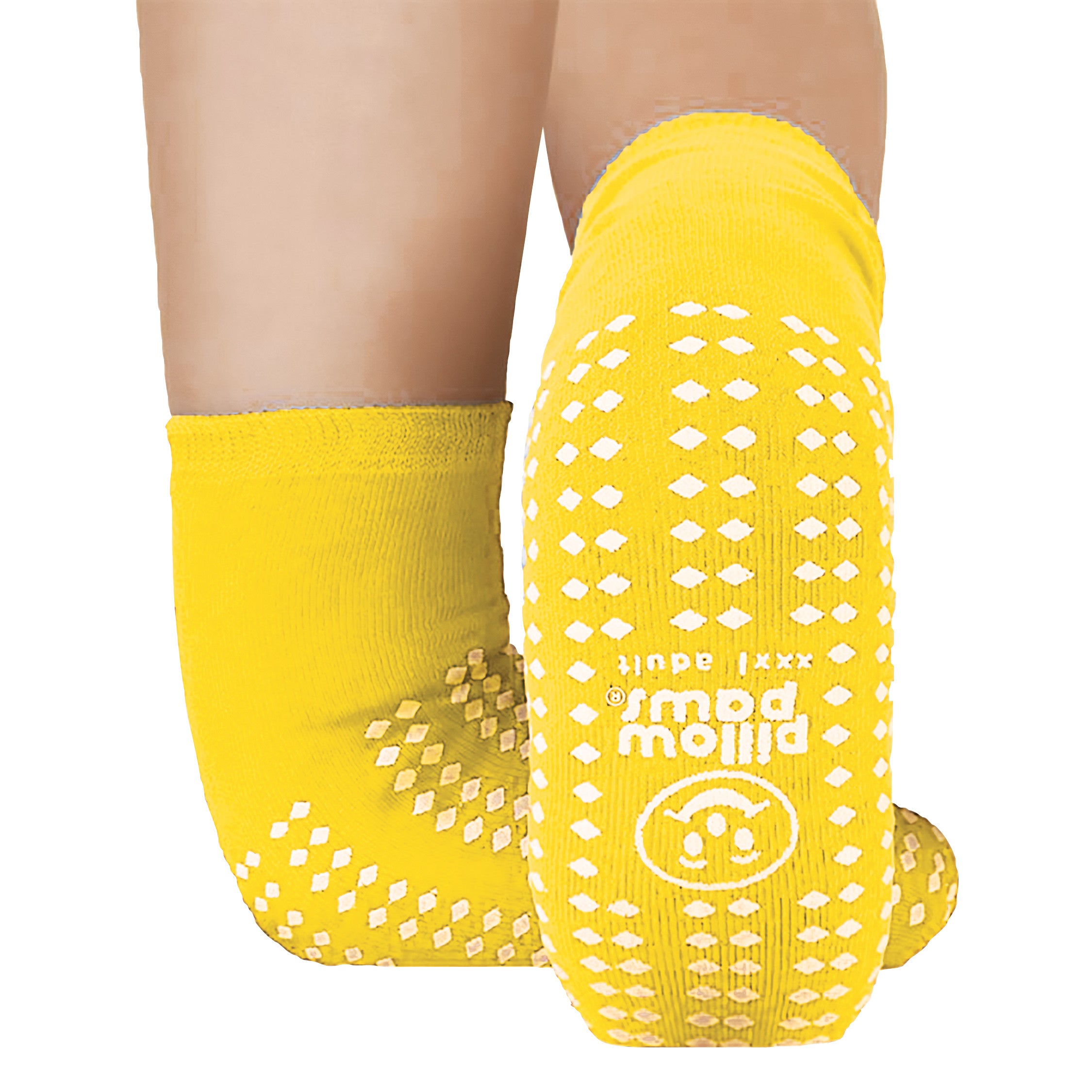 Two legs wearing yellow Pillow Paws Double Print Risk-Alert Socks with non-slip white patterns on the soles and sides.