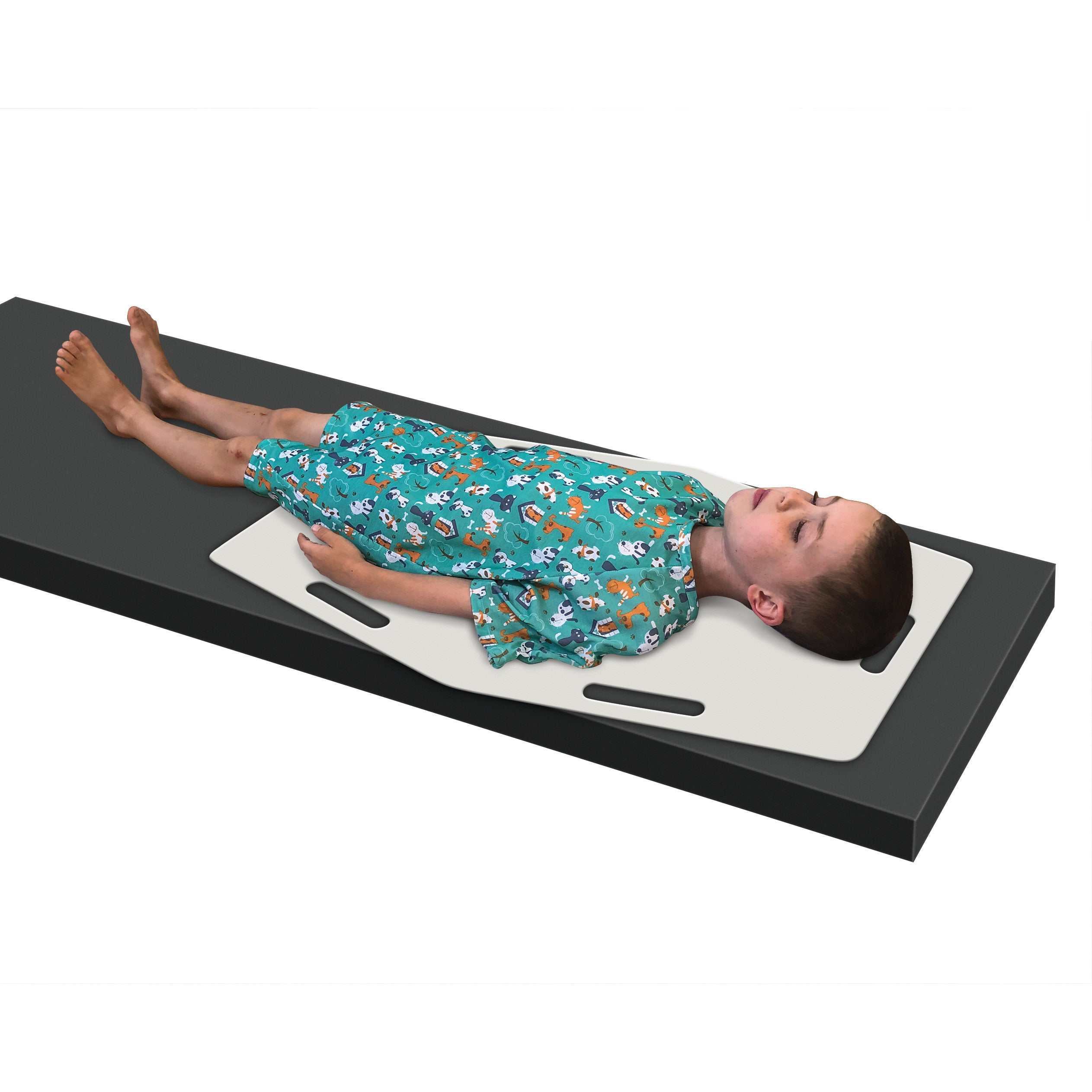 A child lies on an AliMed AliSlide Half Shifter, a white sliding board, wearing a green hospital gown with animal prints.