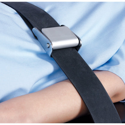 A person is secured with an AliMed Economy Strap across their body, resting on a light blue surface.