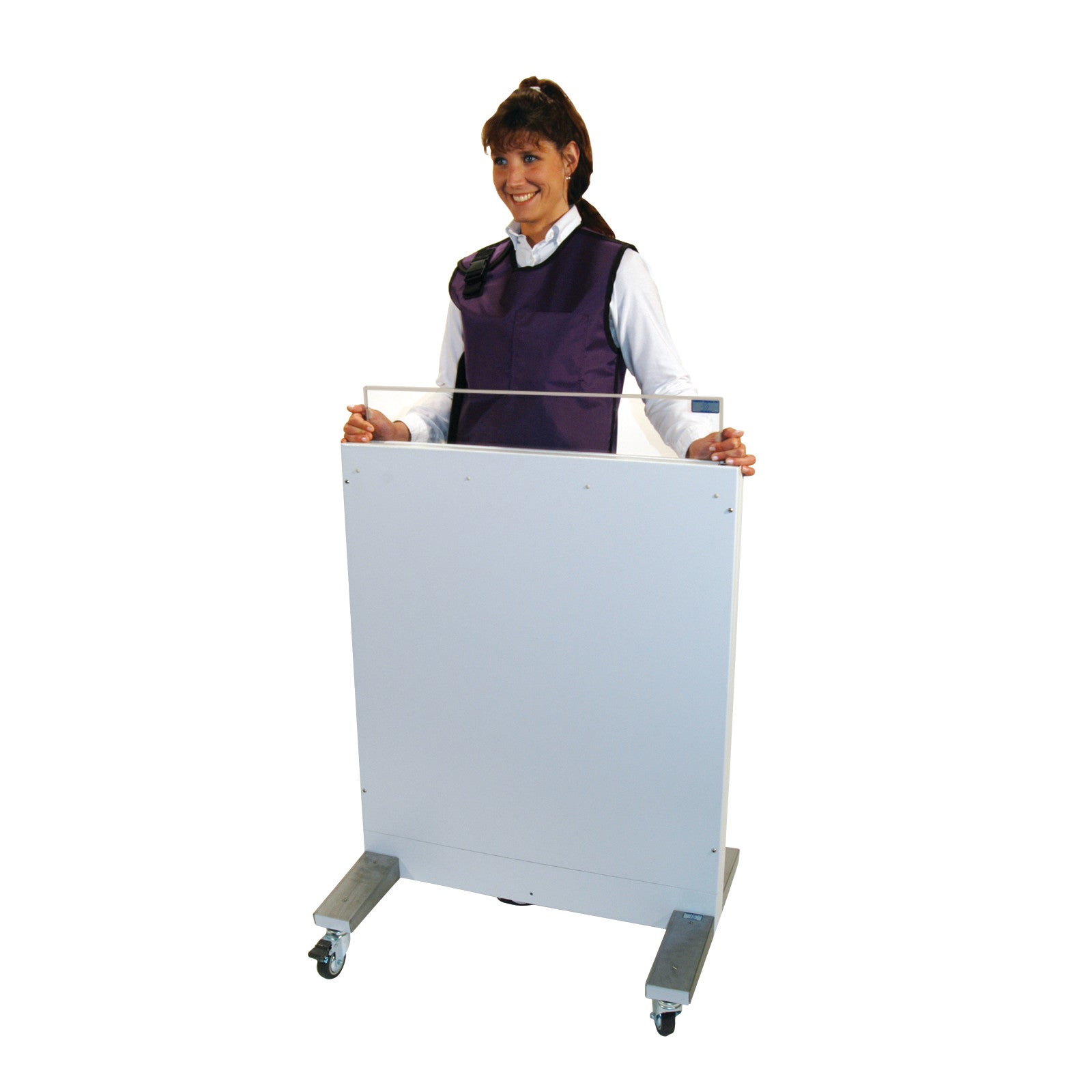 A person stands behind a RayShield Adjust-A-Height Barrier, wearing a protective vest. The barrier is on wheels for easy mobility.