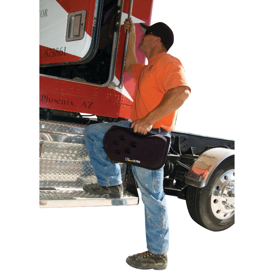 A person climbs into a truck cab holding a Gelco GSeat Ultra Portable Gel Seat. The seat is black and has a handle for carrying.