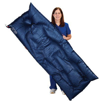 A woman holds the navy AliMed Universal Bean Bag Positioner, a cushion used for medical positioning, against a white background.