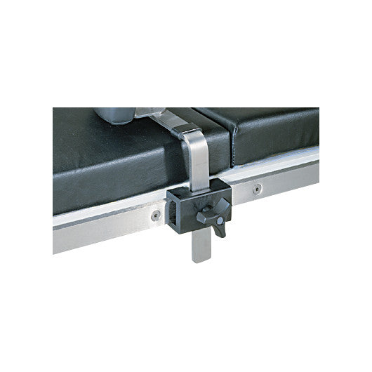 An Allen Side Rail Clamp attached to the side of a black padded hospital bed or table.