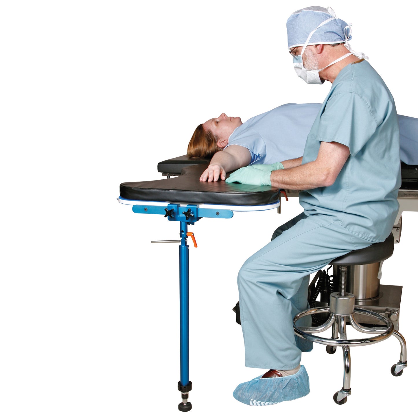 A healthcare professional sets up an AliMed Pneumatic Hand Table Leg, positioned beside a patient on an operating table.