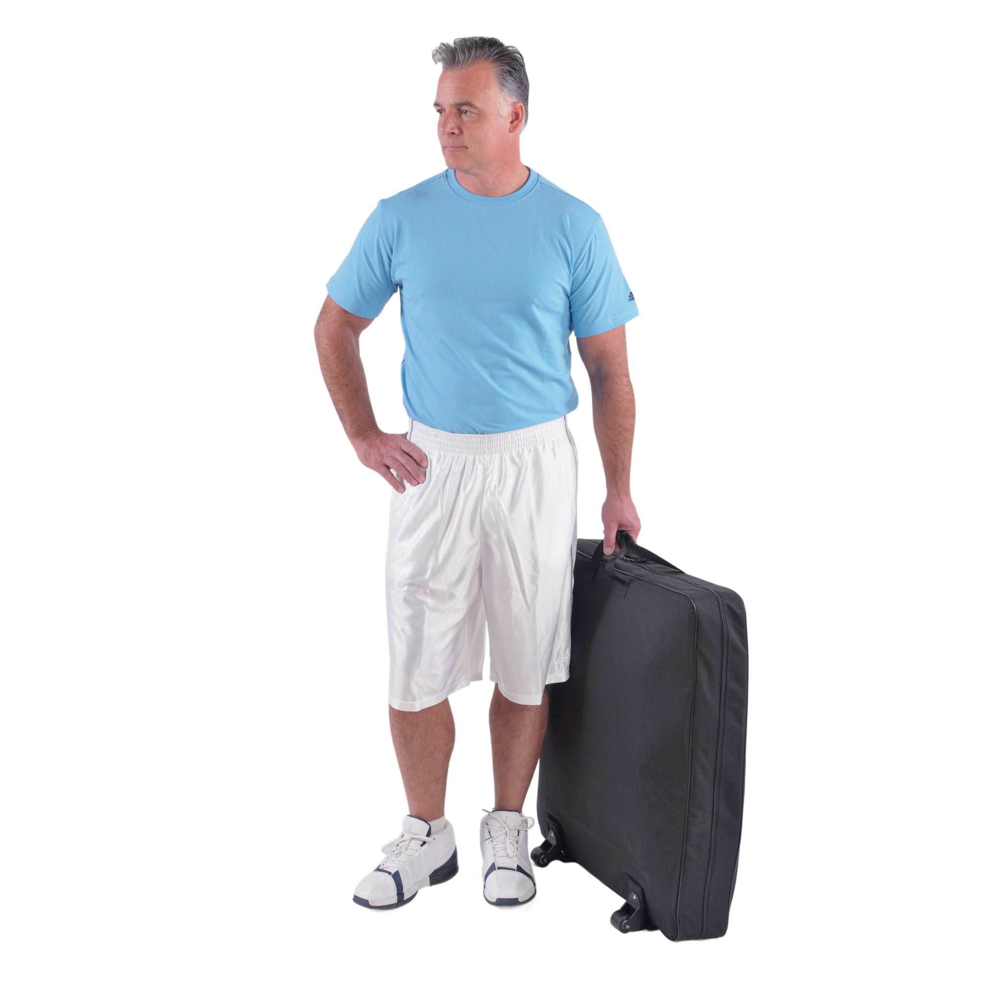 A man in a blue shirt and white shorts holds the wheeled carrying case for the Saunders Lumbar Traction Device.