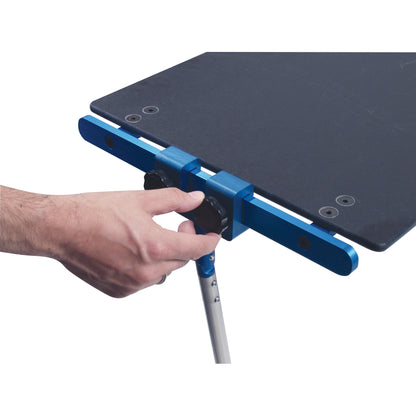 A person's hand adjusts the Attachable Hand Table Leg, which is a detachable blue support mechanism attached to a table edge.
