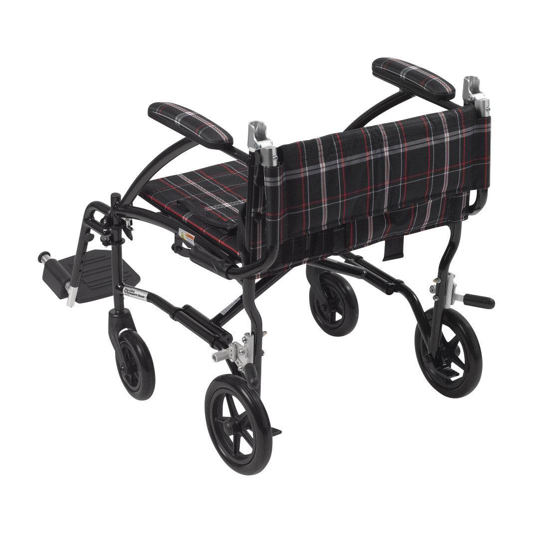 A Drive Medical Fly-Lite Aluminum Transport Chair. It features a lightweight frame and a plaid-patterned seat and backrest.