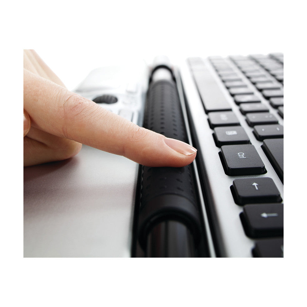 A person's finger interacts with the Contour RollerMouse Red positioned below a keyboard, demonstrating its ergonomic design.
